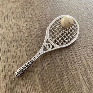 St John Tennis racket brooch pin. Silver tone, racquet ball white enamel.